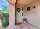 Inviting front entrance with decorative wreath, potted plant, and a welcoming doormat at 20801 N 90Th Pl # 271, Scottsdale, AZ 85255