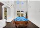 Bright game room with high ceilings features a pool table and views of the pool outside at 20801 N 90Th Pl # 271, Scottsdale, AZ 85255