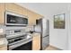 Modern kitchen featuring stainless steel appliances, light wood cabinetry, and beautiful granite countertops at 20801 N 90Th Pl # 271, Scottsdale, AZ 85255
