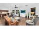 Bright living room features a wet bar, hard wood floors, a flat screen tv, and comfortable leather furniture at 20801 N 90Th Pl # 271, Scottsdale, AZ 85255