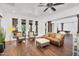 Bright living room features hardwood floors, comfortable leather furniture, and multiple windows at 20801 N 90Th Pl # 271, Scottsdale, AZ 85255
