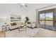 Bright living room with modern decor, stylish furnishings, and a sliding glass door to the balcony at 20801 N 90Th Pl # 271, Scottsdale, AZ 85255