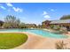 Relaxing community pool area with lush green lawn and desert plants at 20801 N 90Th Pl # 271, Scottsdale, AZ 85255