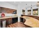 This wet bar has a mini fridge, built-in microwave, marble countertops, and pendant lighting at 20801 N 90Th Pl # 271, Scottsdale, AZ 85255