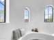 Cozy window nook features arched windows, a built-in bench, and stylish decor at 20801 N 90Th Pl # 271, Scottsdale, AZ 85255