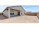 Back exterior view of home with covered patio, sliding glass door, and unfinished backyard at 23417 W Burton Ave, Buckeye, AZ 85326