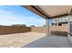 Unfinished backyard with concrete patio, block wall fencing and plenty of space for personalization at 23417 W Burton Ave, Buckeye, AZ 85326