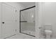Contemporary bathroom with glass enclosed shower, black trim and hardware, and marble tile flooring at 23417 W Burton Ave, Buckeye, AZ 85326