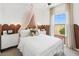 Cozy bedroom with scallop design, decorative canopy, and ample natural light at 23417 W Burton Ave, Buckeye, AZ 85326