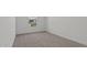 Clean, carpeted bedroom space, bathed in soft, natural light from a window at 23417 W Burton Ave, Buckeye, AZ 85326