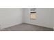 Serene bedroom featuring a window allowing natural light and neutral colored carpet at 23417 W Burton Ave, Buckeye, AZ 85326