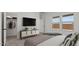 Well-lit bedroom with a view, storage console with TV and closet with open shelving for organization at 23417 W Burton Ave, Buckeye, AZ 85326