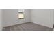 Neutral bedroom featuring carpeting, a window for light, and a clean and minimal design at 23417 W Burton Ave, Buckeye, AZ 85326