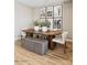 Dining area with an oval table, accent chairs, bench seating, and desert-themed art at 23417 W Burton Ave, Buckeye, AZ 85326