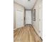 Clean entryway with wood-look flooring, white doors, and neutral wall colors at 23417 W Burton Ave, Buckeye, AZ 85326