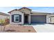Beautiful home showcasing a stone facade, two-car garage, and desert landscaping at 23417 W Burton Ave, Buckeye, AZ 85326