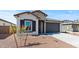 Charming home featuring stone accents, a two-car garage, and a low-maintenance desert landscape at 23417 W Burton Ave, Buckeye, AZ 85326
