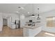 Modern kitchen features a spacious island with a breakfast bar and stainless steel appliances at 23417 W Burton Ave, Buckeye, AZ 85326