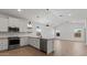 Bright kitchen featuring white cabinets, stainless steel appliances, and stylish fixtures at 23417 W Burton Ave, Buckeye, AZ 85326