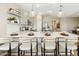 Open kitchen with island seating, pendant lighting, quartz countertops, and stainless steel appliances at 23417 W Burton Ave, Buckeye, AZ 85326