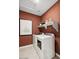 Functional laundry room with modern appliances and shelving at 23417 W Burton Ave, Buckeye, AZ 85326