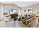 Bright living room with large windows, comfortable seating, and modern decor at 23417 W Burton Ave, Buckeye, AZ 85326