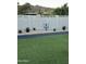 Well-maintained backyard with artificial grass and desert landscaping at 2426 E Turquoise Dr, Phoenix, AZ 85028