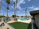 Backyard with pool, lounge furniture, manicured lawn, and tall palm trees at 2426 E Turquoise Dr, Phoenix, AZ 85028