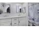 Modern bathroom with dual sinks, decorative mirrors, and a glass-enclosed shower featuring marble tile at 2426 E Turquoise Dr, Phoenix, AZ 85028