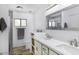 Bathroom featuring dual sinks, quartz countertops, and walk-in shower at 2426 E Turquoise Dr, Phoenix, AZ 85028