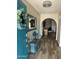 Light and airy entry showcases a decorative mirror, glass table and bench, and charming succulent wreath at 2426 E Turquoise Dr, Phoenix, AZ 85028
