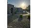 Desert landscaping and a curved walkway lead to the arched entryway of this single-story home at 2426 E Turquoise Dr, Phoenix, AZ 85028