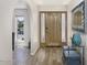 Foyer area with wood flooring, a wooden door, and views of the front yard at 2426 E Turquoise Dr, Phoenix, AZ 85028