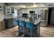 Modern kitchen with gray cabinetry, stainless steel appliances, and a central island with seating at 2426 E Turquoise Dr, Phoenix, AZ 85028
