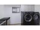 Laundry area with front-load washer and dryer and overhead storage cabinets at 2426 E Turquoise Dr, Phoenix, AZ 85028