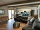 Open-concept living room and kitchen with exposed beam ceiling and access to the backyard at 2426 E Turquoise Dr, Phoenix, AZ 85028