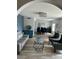 Open-concept living room with light gray sofa, charcoal chairs, and elegant decor flows into dining area at 2426 E Turquoise Dr, Phoenix, AZ 85028
