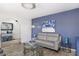 Cozy living room featuring blue accent wall, comfortable seating, and decorative elements at 2426 E Turquoise Dr, Phoenix, AZ 85028