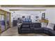 Open-concept living room featuring exposed beams, sleek furniture, and seamless transition to the updated kitchen at 2426 E Turquoise Dr, Phoenix, AZ 85028