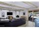 Comfortable living room with decorative fireplace, modern lighting, wood-look tile floors, and pool view at 2426 E Turquoise Dr, Phoenix, AZ 85028