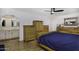 Bright bedroom featuring wood floors, arched entrance, and attached bathroom at 2426 E Turquoise Dr, Phoenix, AZ 85028