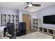 Office space with built-in shelves, wood floors, and a ceiling fan at 2426 E Turquoise Dr, Phoenix, AZ 85028