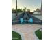 Outdoor fireplace on tiled patio with colorful Adirondack chairs at 2426 E Turquoise Dr, Phoenix, AZ 85028