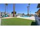 Backyard oasis featuring a swimming pool, lush turf, patio area, and mountain views, perfect for entertaining at 2426 E Turquoise Dr, Phoenix, AZ 85028