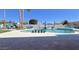 Gorgeous backyard pool featuring cool blue water, palm trees, stylish furniture, and desert landscaping at 2426 E Turquoise Dr, Phoenix, AZ 85028