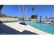 Inviting pool area with turquoise water, palm trees, patio furniture, and mountain views, perfect for outdoor entertaining at 2426 E Turquoise Dr, Phoenix, AZ 85028