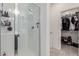 Bright bathroom with a sleek glass shower and a well-organized walk-in closet at 2660 S Equestrian Dr # 103, Gilbert, AZ 85295