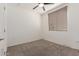 Simple, carpeted bedroom with a ceiling fan and a bright neutral wall color at 2660 S Equestrian Dr # 103, Gilbert, AZ 85295