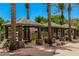Inviting community cabana area with shaded seating and palm trees offers residents an outdoor space for relaxation at 2660 S Equestrian Dr # 103, Gilbert, AZ 85295