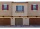 Townhome featuring a private garage with decorative shutters adding charm at 2660 S Equestrian Dr # 103, Gilbert, AZ 85295